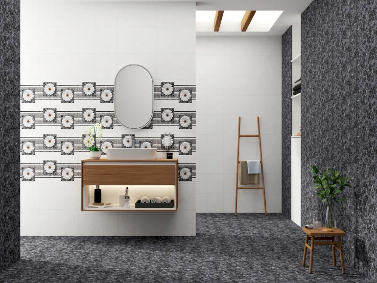 Stylish grey bathroom featuring a sink with cabinet, mirror, and black marble design